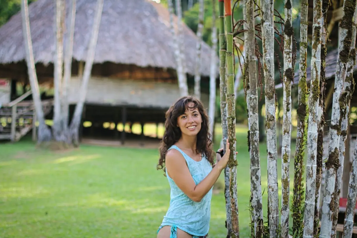 girl standing against palms in camp cisame french guiana