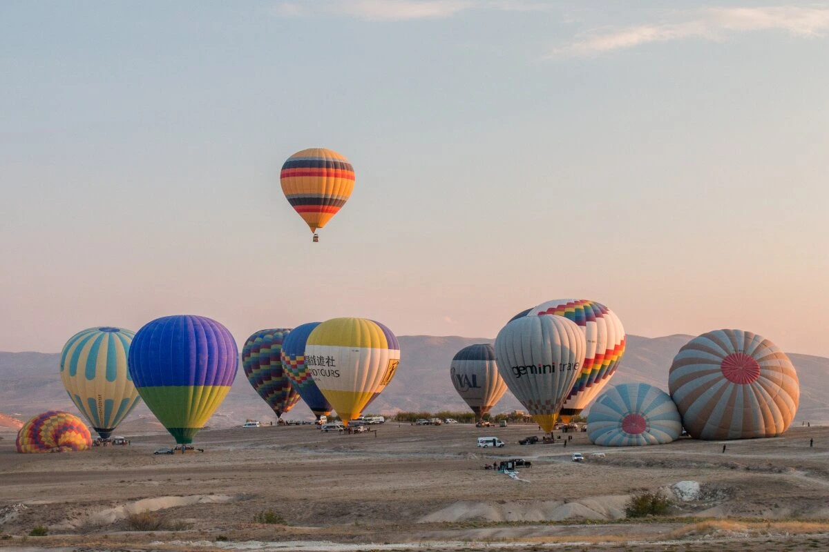 hot air balloons taking off in Goreme valley Cappadocia