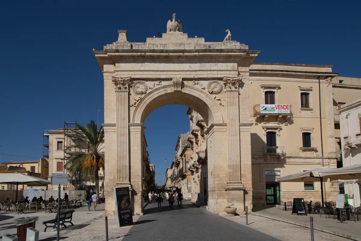 baroque gate opening on a large street corso vittorio emanuele porta ferdinandea noto travel guide
