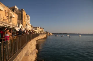 view of promenade at sunset ortigia island walk to maniace castle